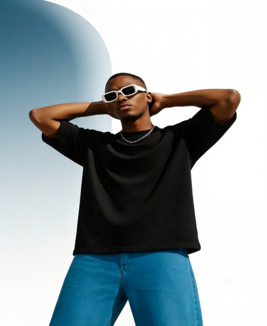 Person wearing a black shirt and blue jeans with white sunglasses against a light blue background