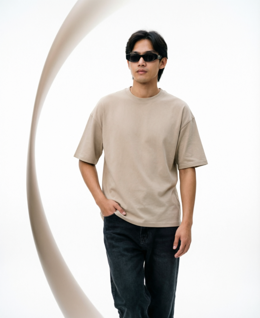 Man wearing a beige t-shirt and sunglasses against a white background