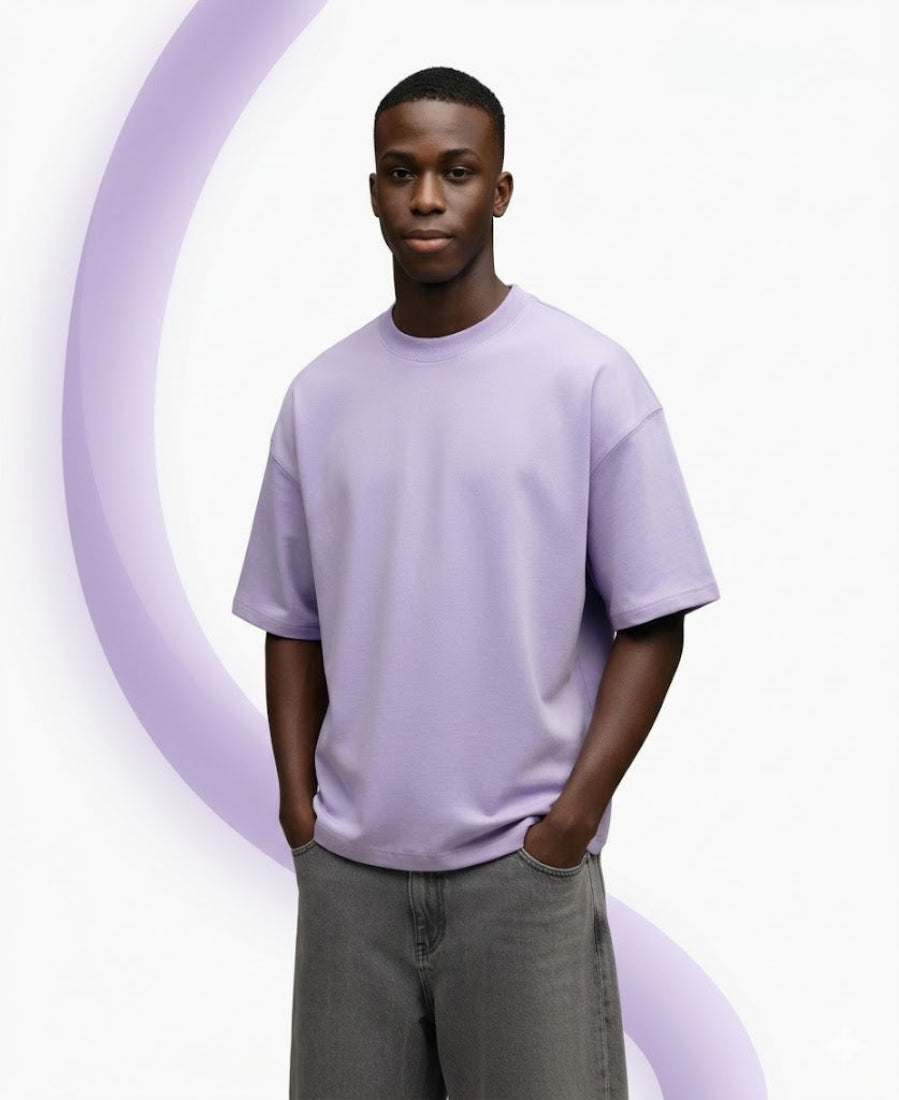 Man wearing a light purple t-shirt and gray pants against a white background
