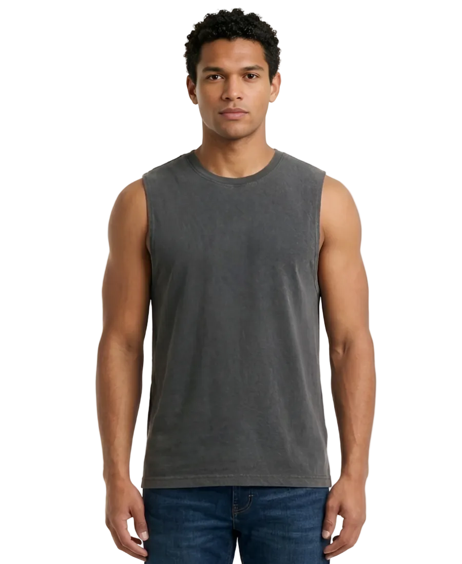 Man wearing a gray sleeveless shirt and blue jeans on a white background