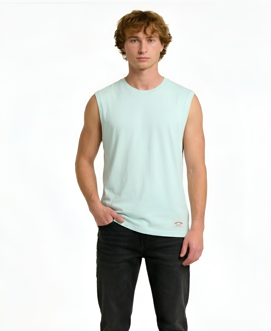Man wearing a light green sleeveless shirt and black pants on a white background