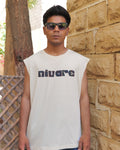 Man wearing a sleeveless shirt with 'nivare' logo standing against a stone wall.