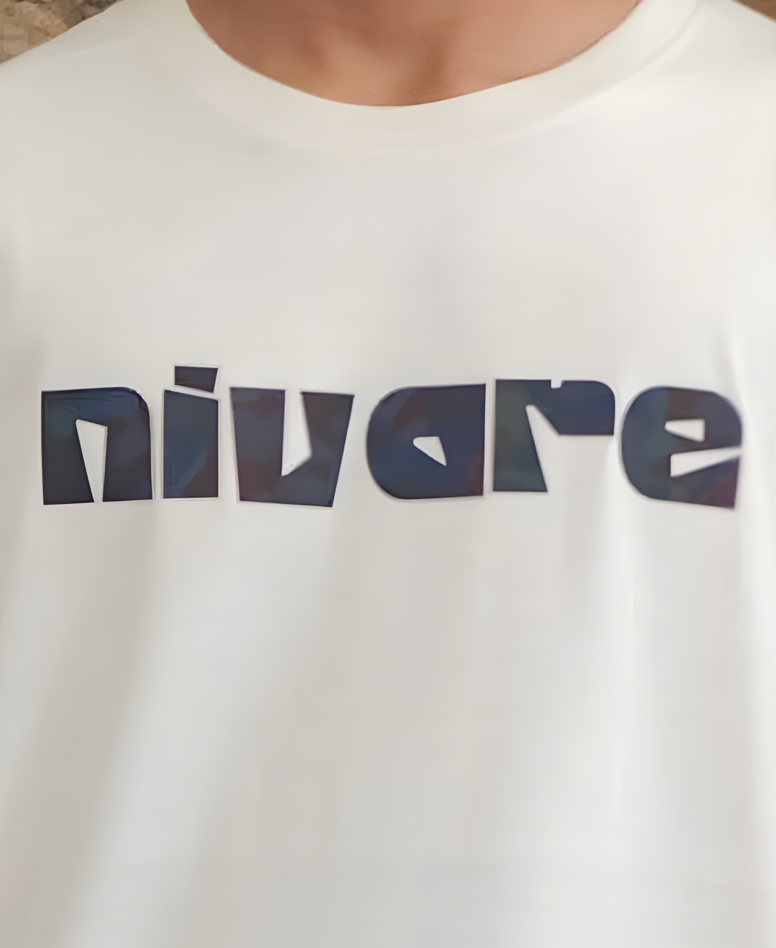White t-shirt with 'nivare' logo on a plain background