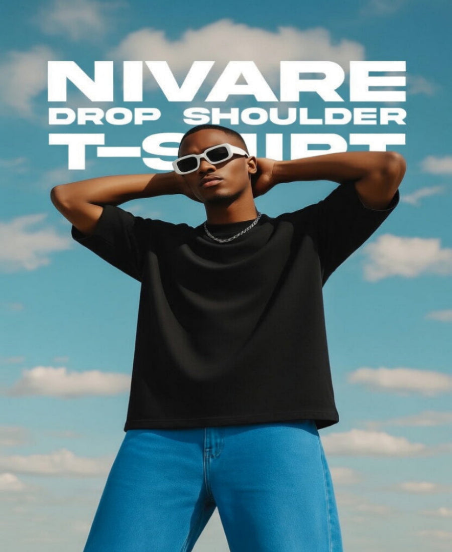 Person wearing a black drop shoulder t-shirt with a blue sky background and 'NIVARE' branding.